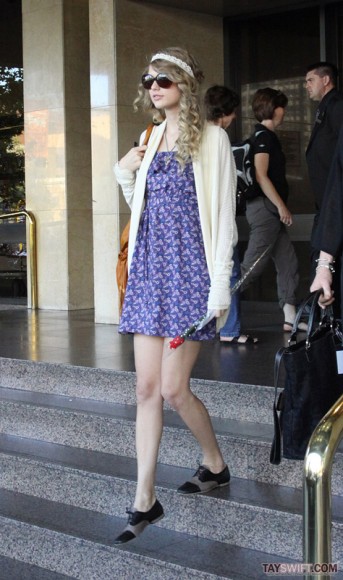 Taylor Swift in a blue dress and cardigan