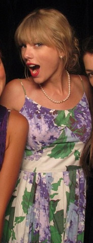 Taylor Swift wearing a floral 50s dress with pearls