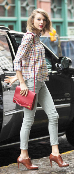 Multi-colored check shirt with jeans and red bag out in New York